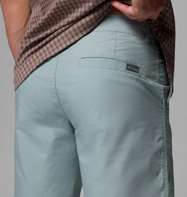 Light blue pants with a brand logo on a gray background