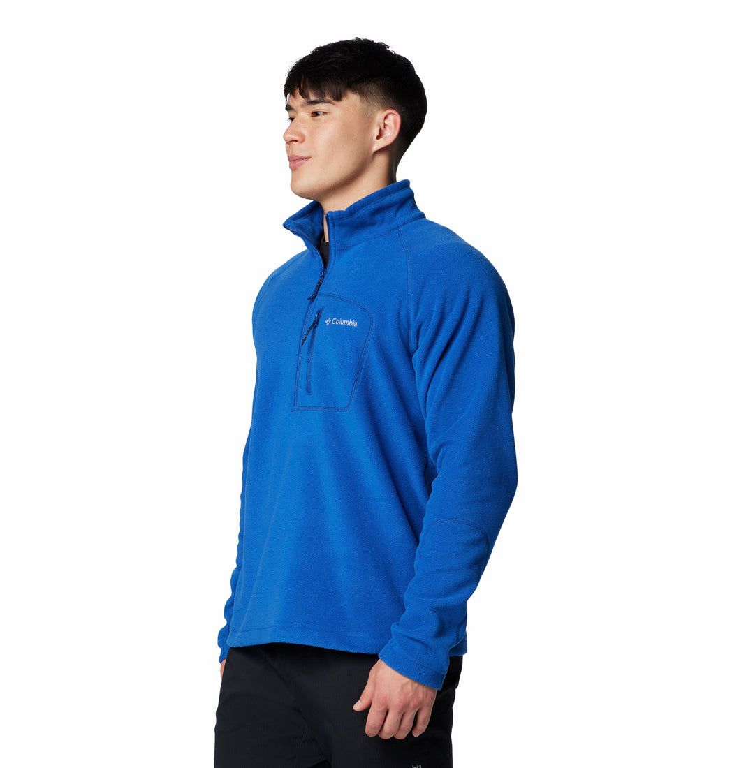 Person wearing a blue pullover with a visible brand logo on a white background