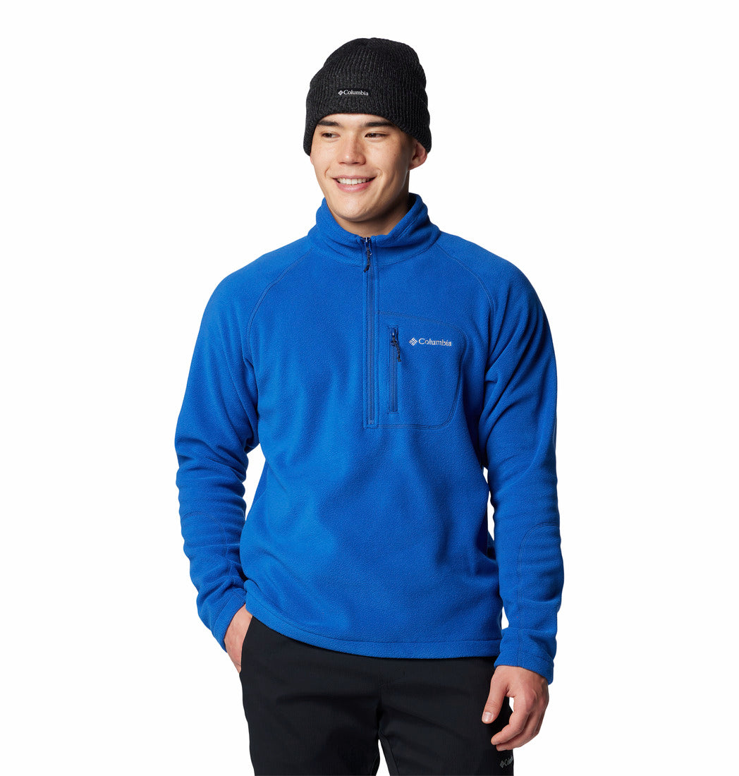 Person wearing a blue pullover with a brand logo on a white background