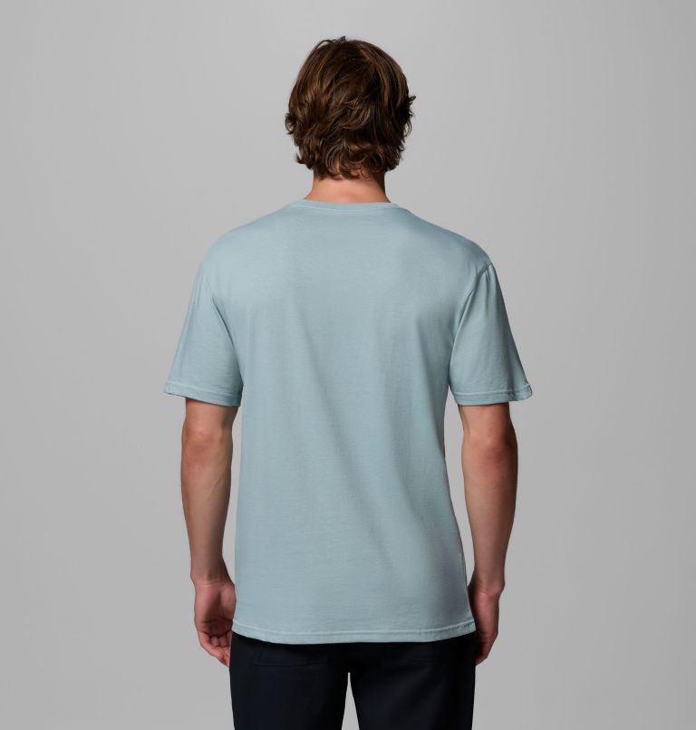 Person wearing a light blue t-shirt against a gray background