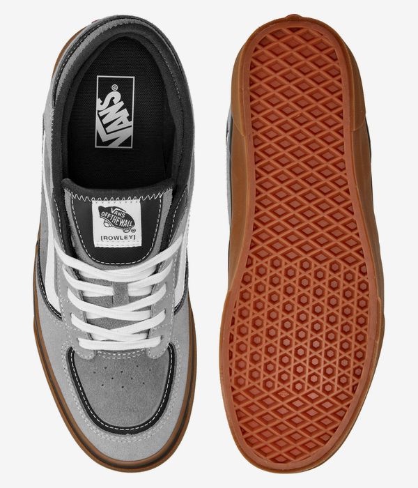 Gray sneakers with white laces and brown soles, featuring Vans branding.
