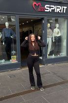 Laura in the Black Flared Trousers paired with the Zip Up Black Hoodie