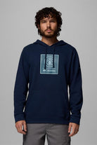 Man wearing a navy blue hoodie with Columbia logo on a gray background
