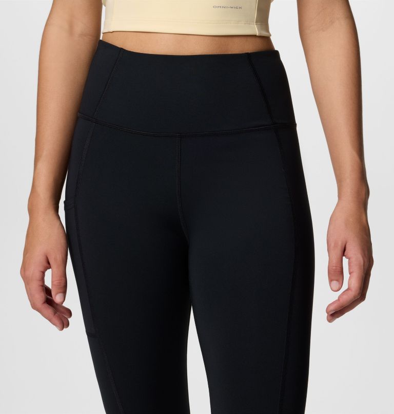 Black high-waisted pants worn by a person on a white background