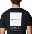 Black t-shirt with Columbia logo and text on the back, worn by a person.