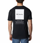 Black t-shirt with Columbia logo and text on the back, worn by a person.