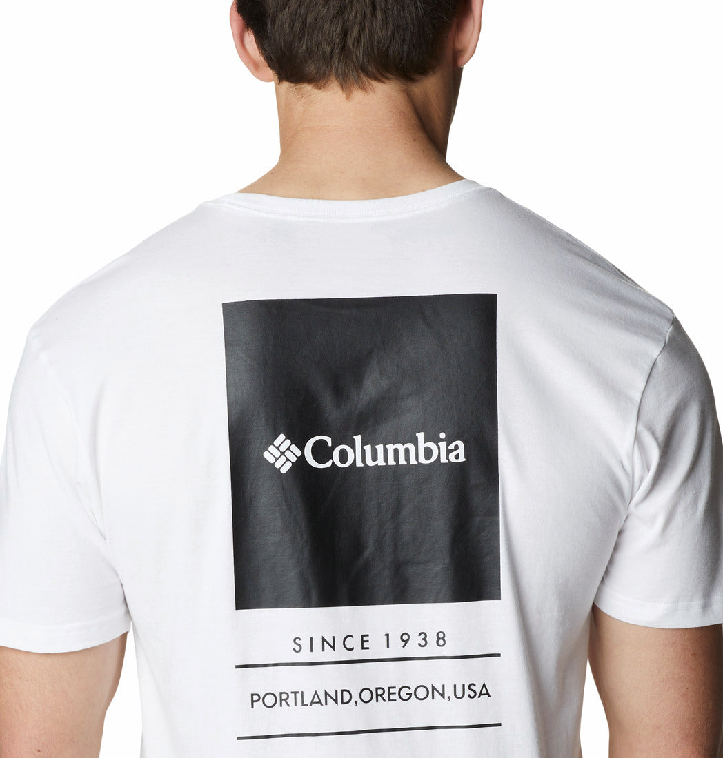 White t-shirt with Columbia logo and text on the back, worn by a person.
