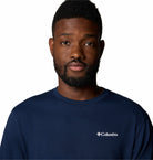 Man wearing a navy Columbia shirt against a white background