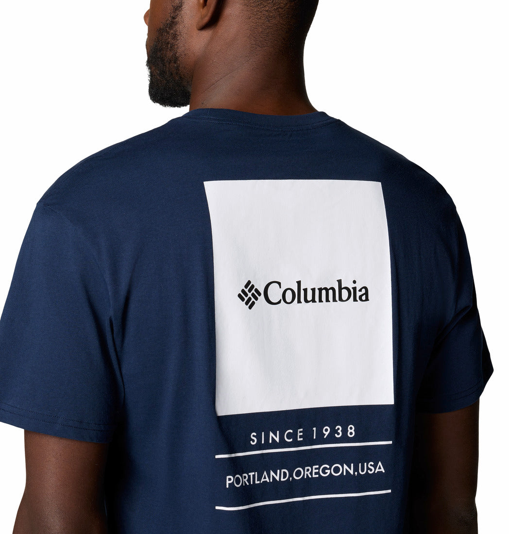 Navy blue t-shirt with Columbia logo and text on the back, worn by a person.