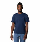 Man wearing a navy blue t-shirt with Columbia logo on a white background