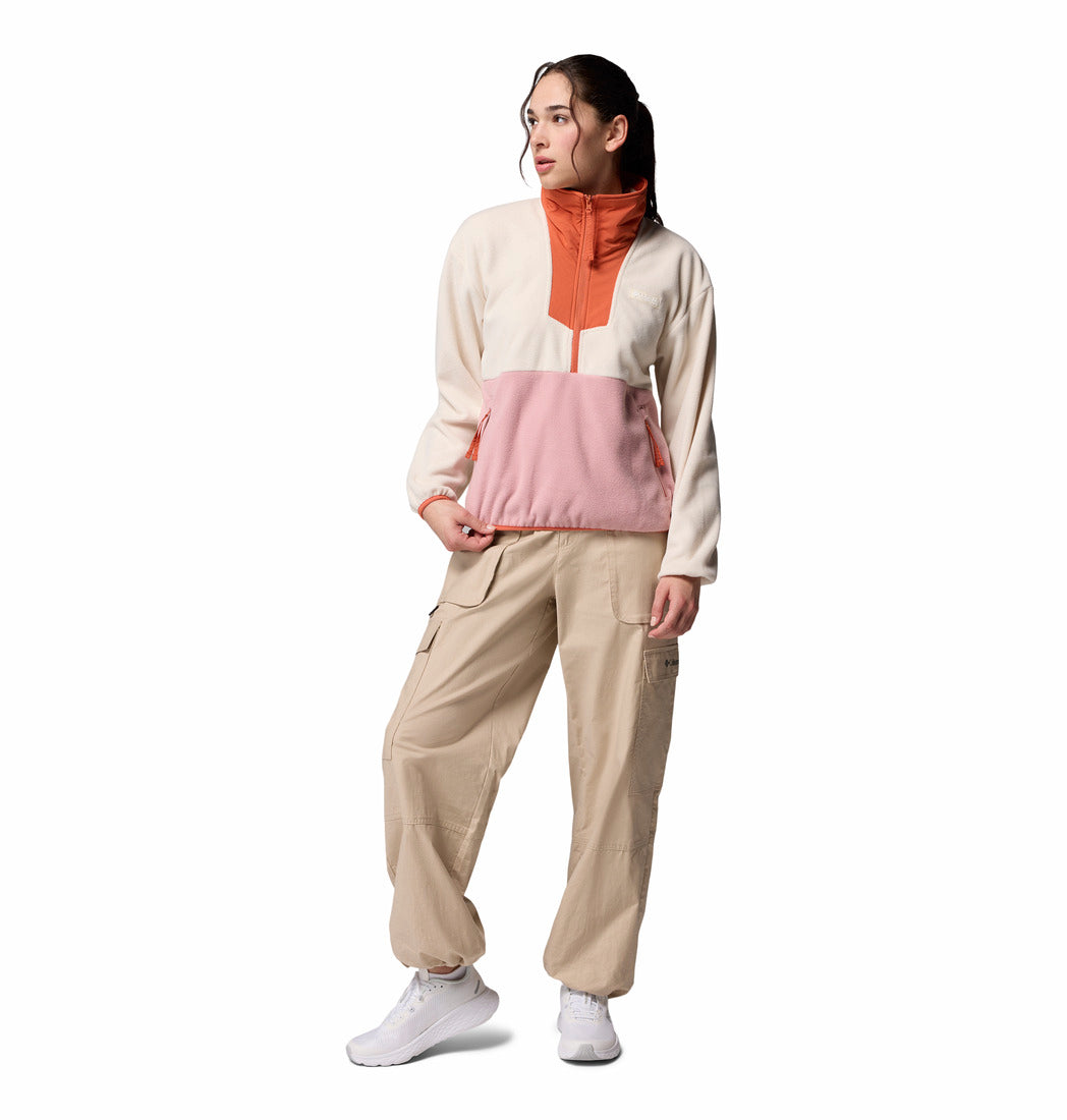 Person wearing a beige and pink outfit with a white background