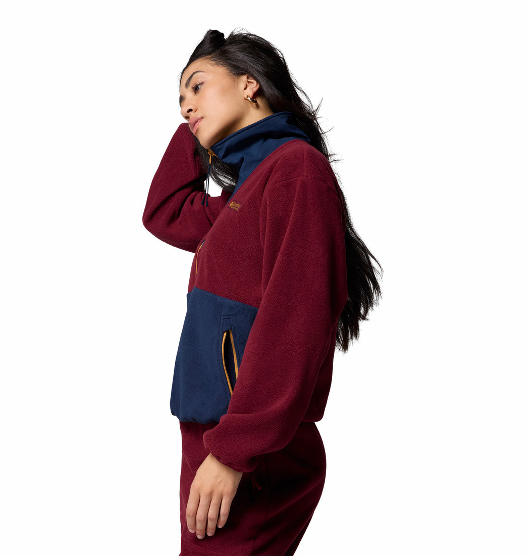Person wearing a red and blue pullover on a white background