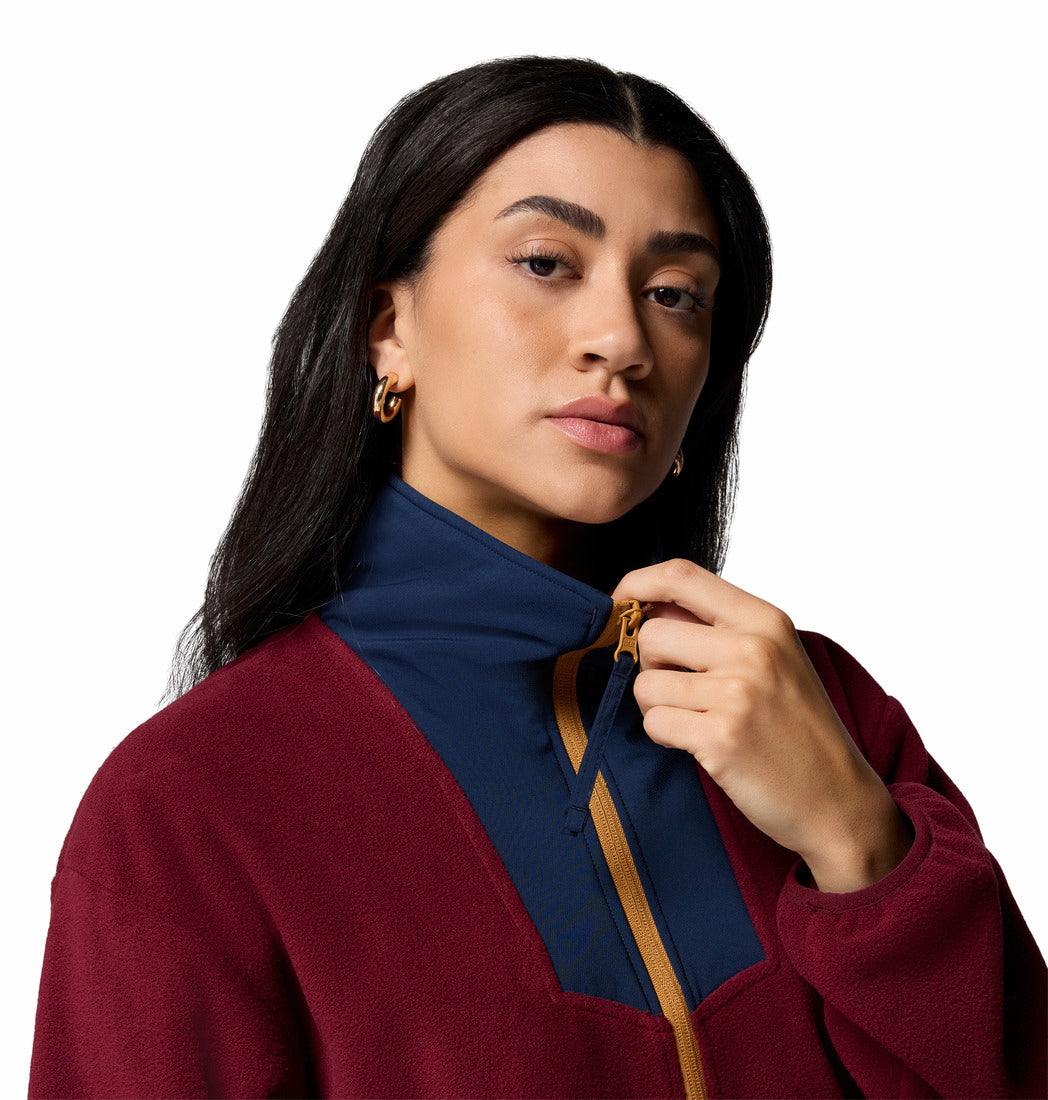 Woman wearing a maroon coat with a blue collar and brown accents on a white background