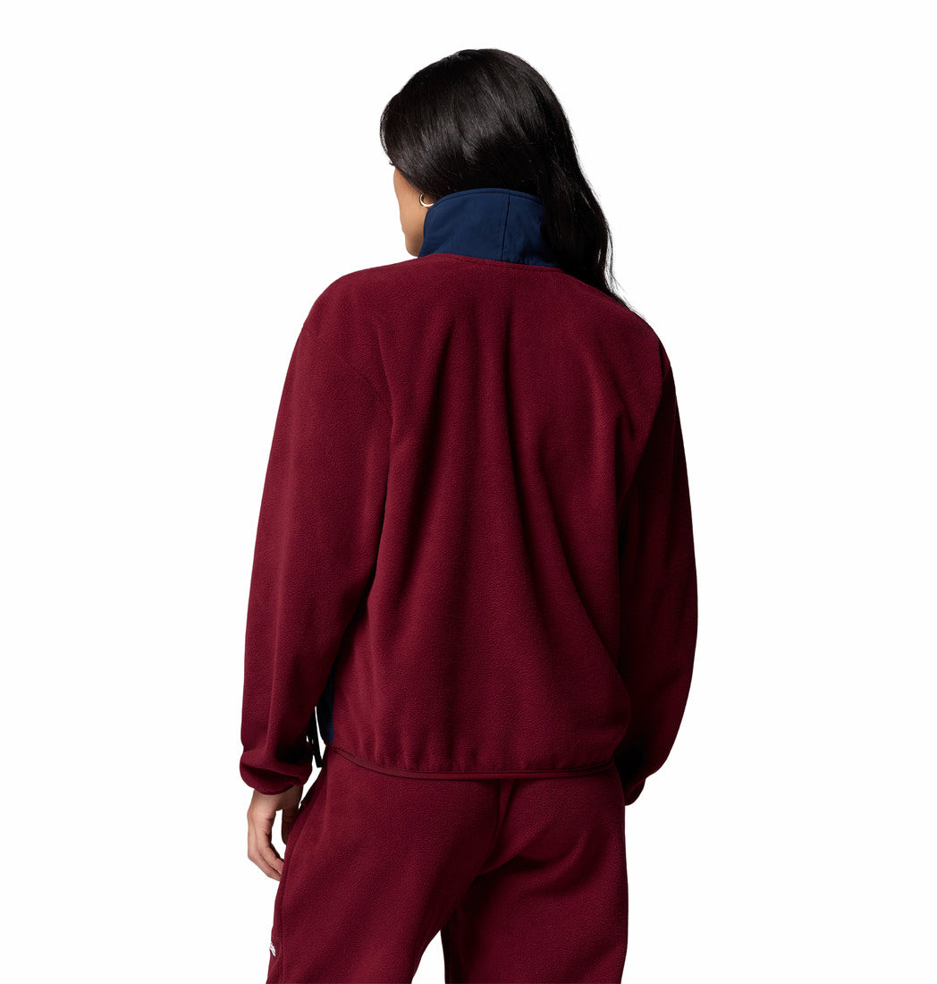 Person wearing a maroon tracksuit on a white background
