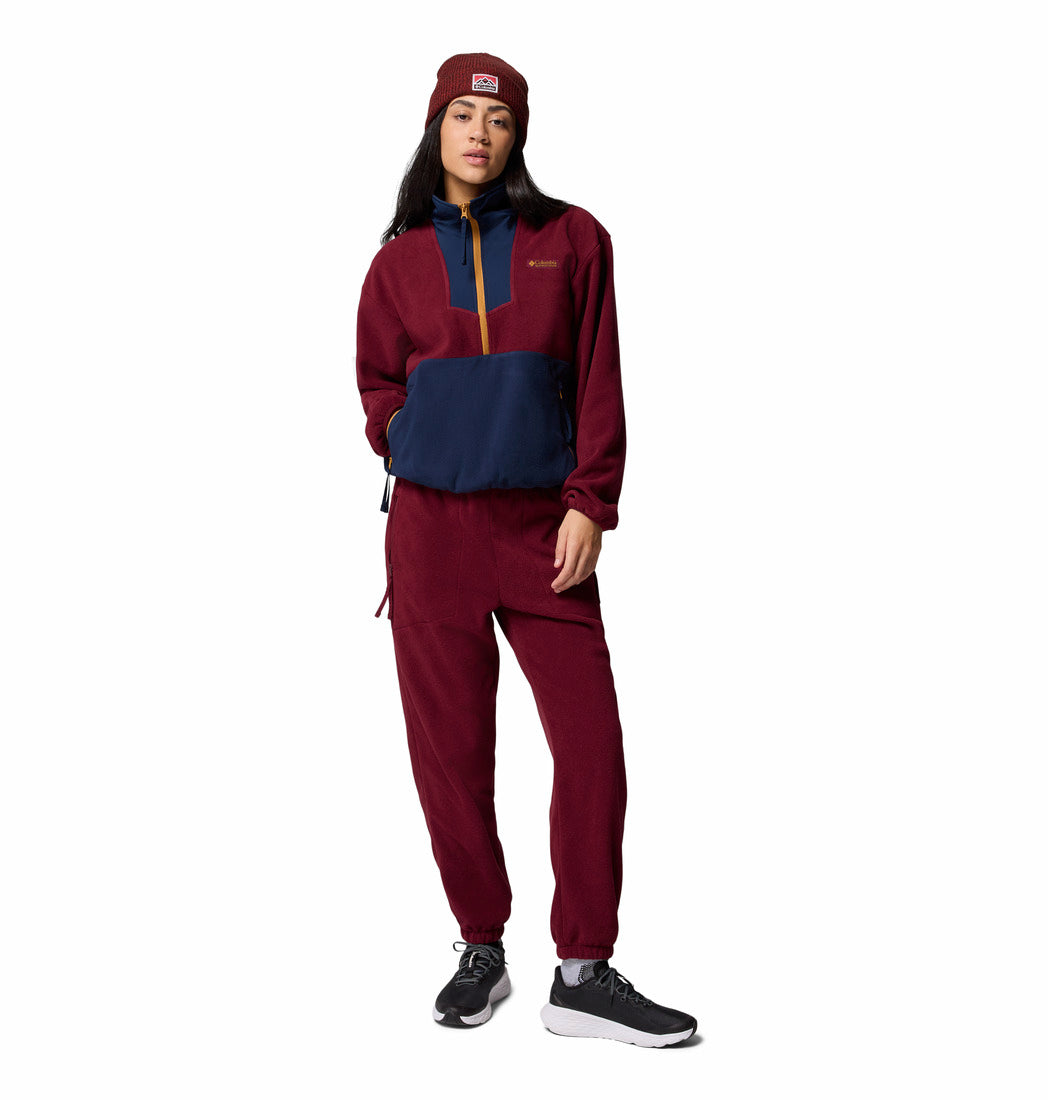 Person wearing a maroon and navy outfit with a matching beanie on a white background