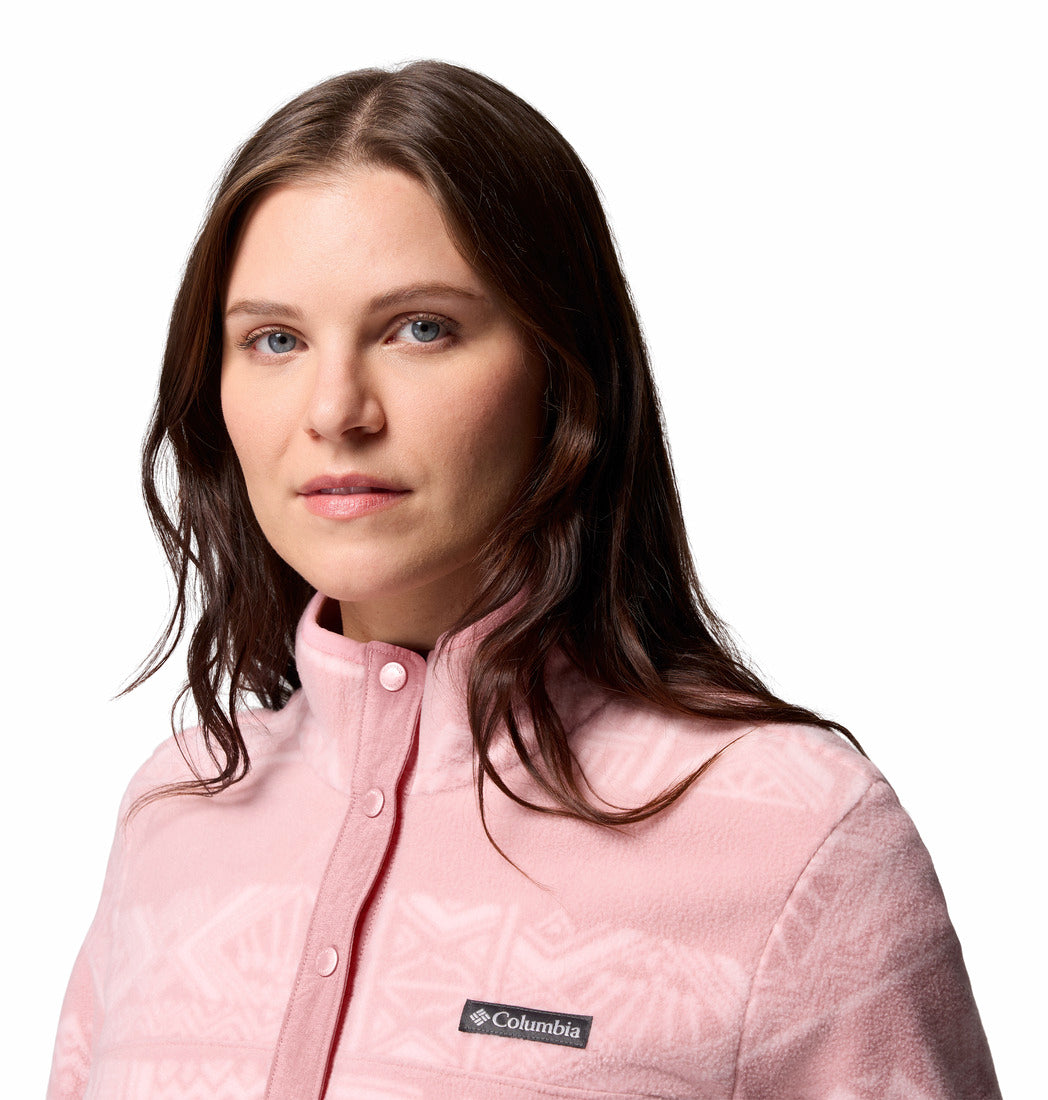 Woman wearing a pink Columbia fleece on a white background