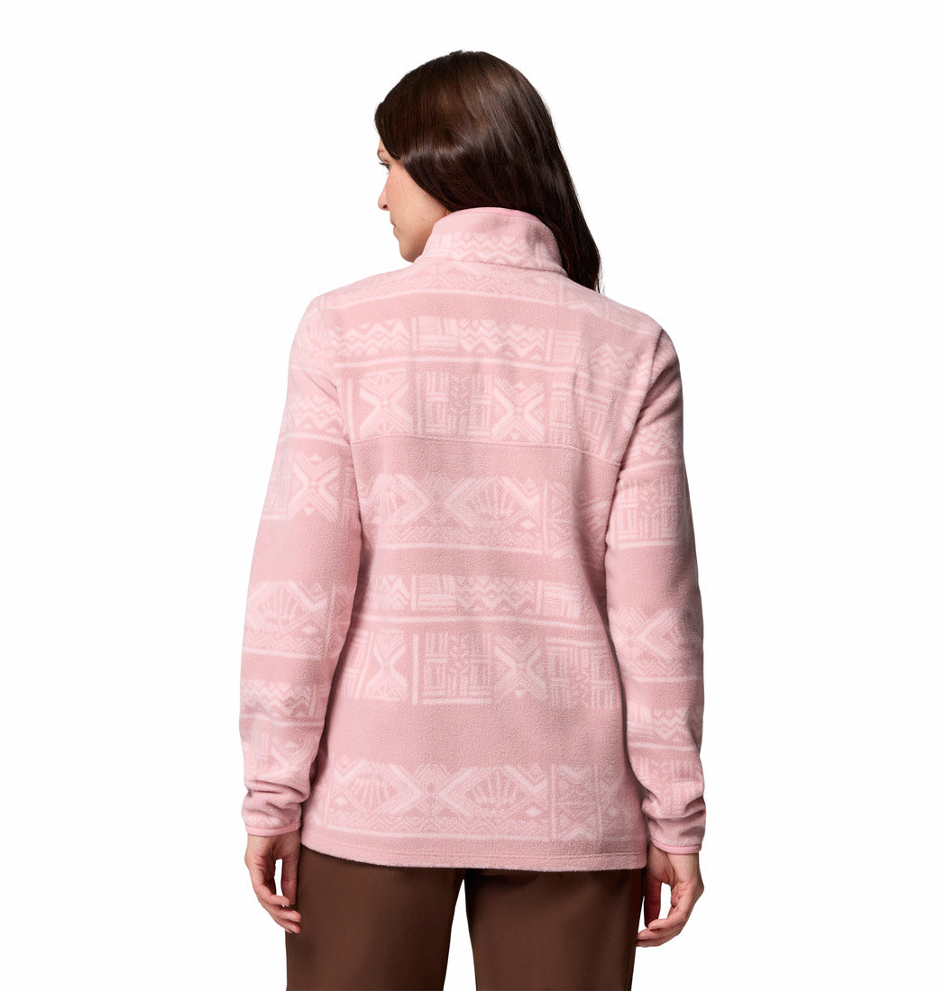 Woman wearing a pink patterned jacket on a white background