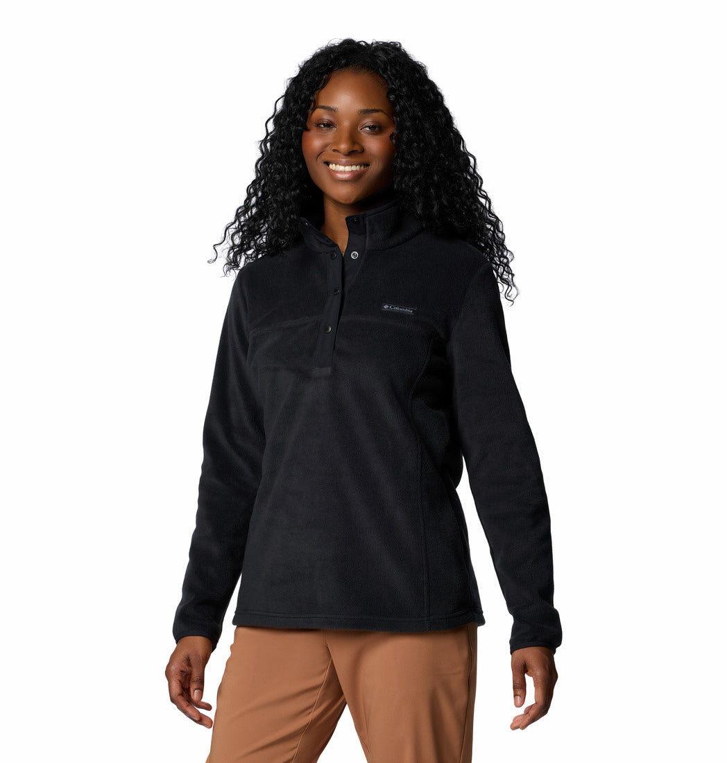 Woman wearing a black fleece pullover with a visible brand logo on a white background