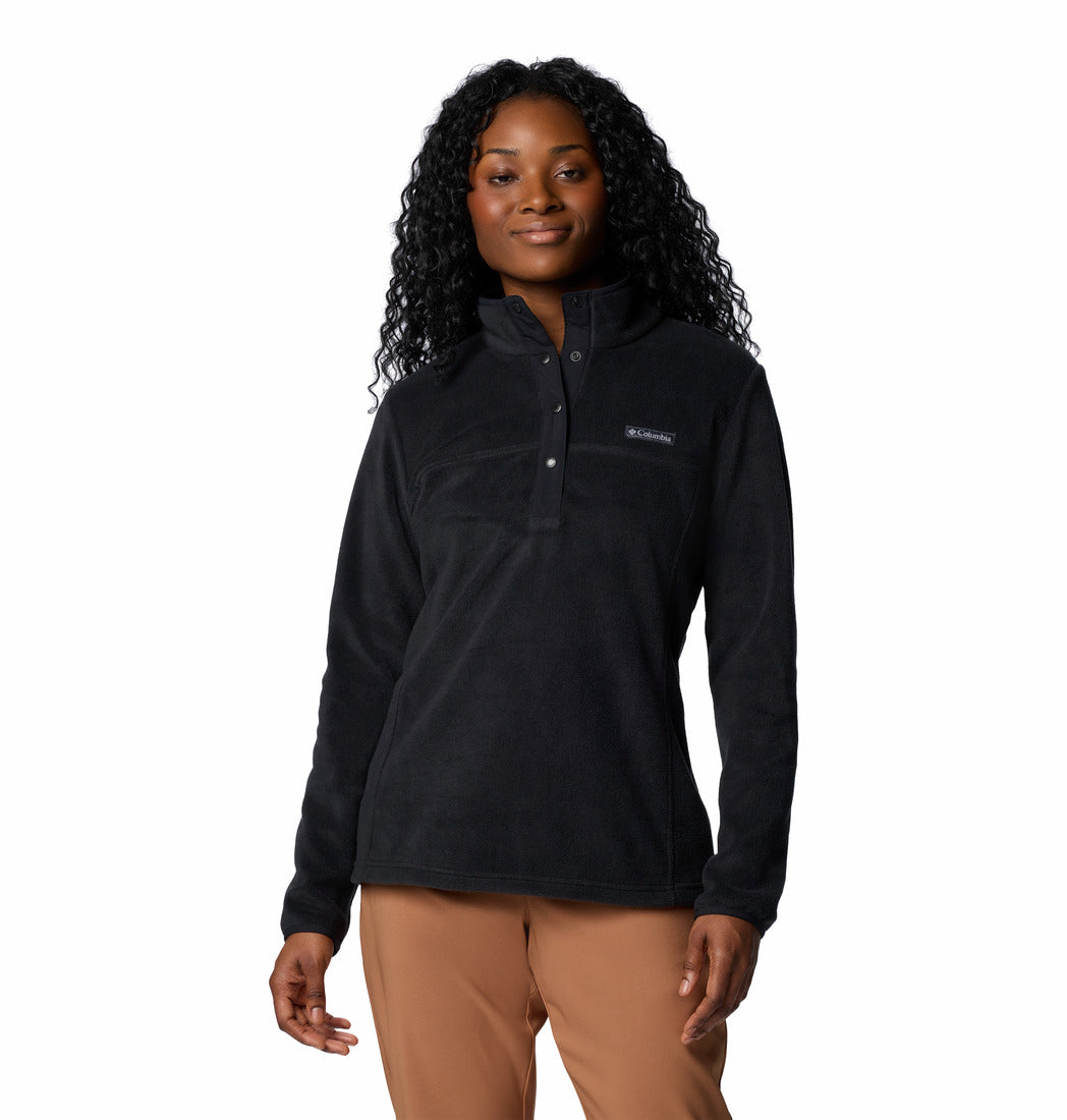 Woman wearing a black fleece pullover with a visible brand logo on a white background