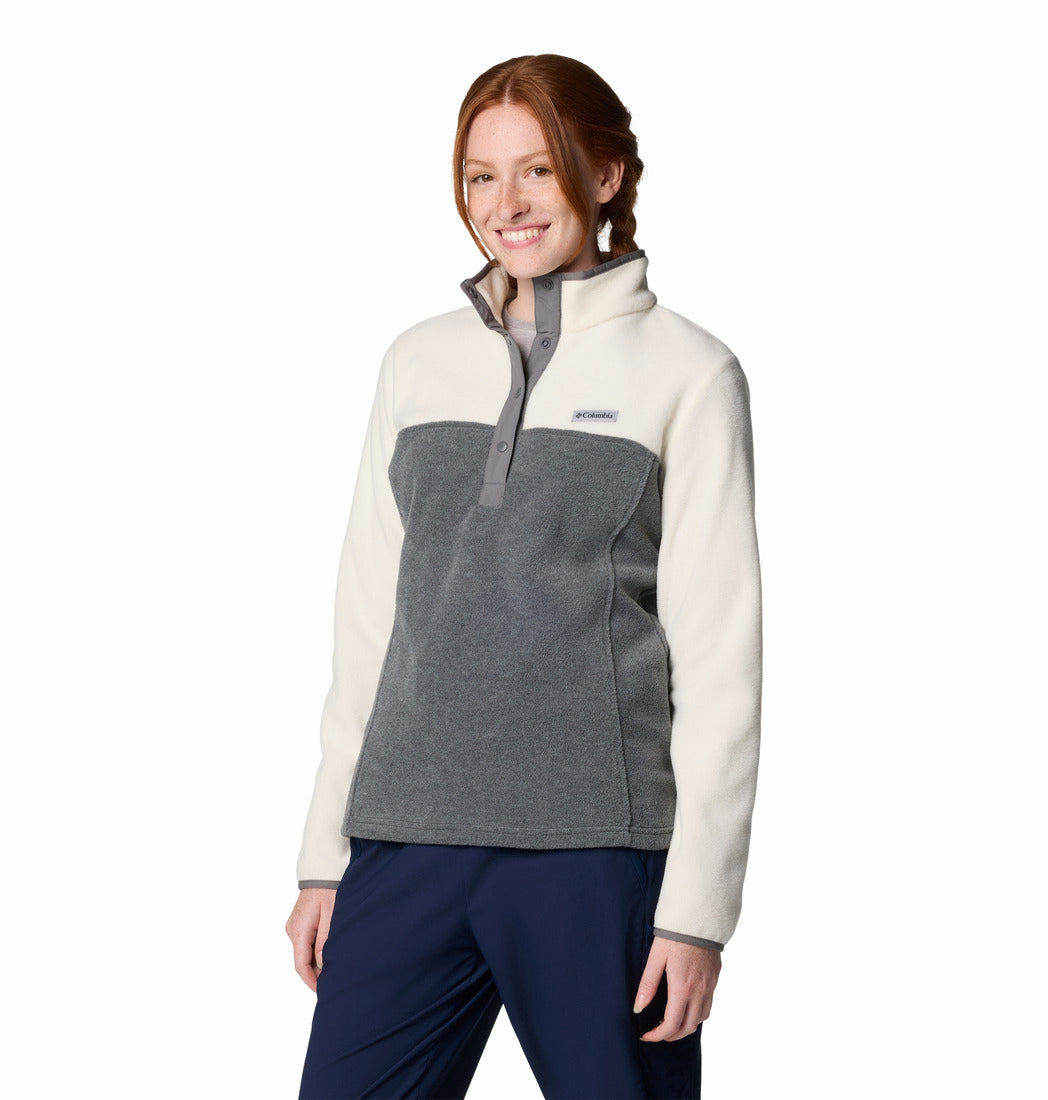 Woman wearing a two-tone fleece jacket with a visible brand logo on a white background