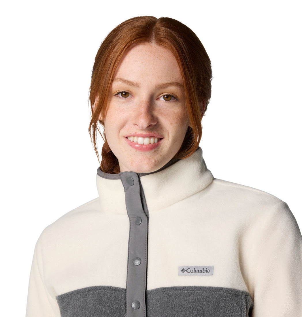 Woman wearing a white and gray Columbia jacket on a white background