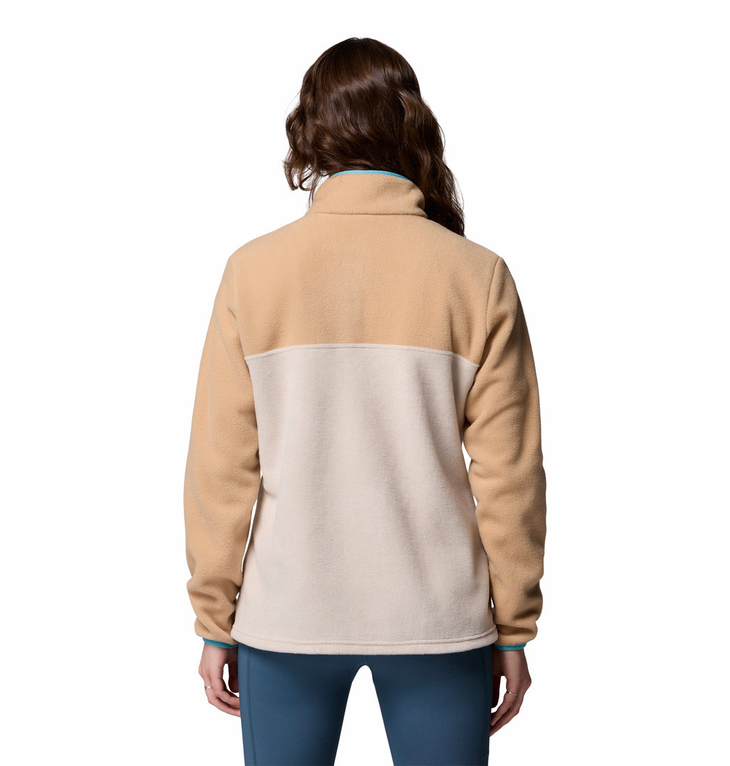 Person wearing a beige and light gray fleece jacket on a white background