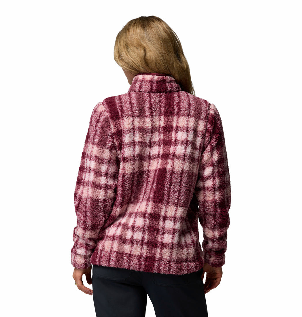 Person wearing a plaid patterned pullover on a white background
