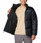 Person wearing a black Columbia jacket on a white background