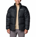 Person wearing a black Columbia jacket on a white background