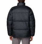 Black puffer jacket worn by a person on a white background