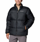 Person wearing a black Columbia jacket on a white background