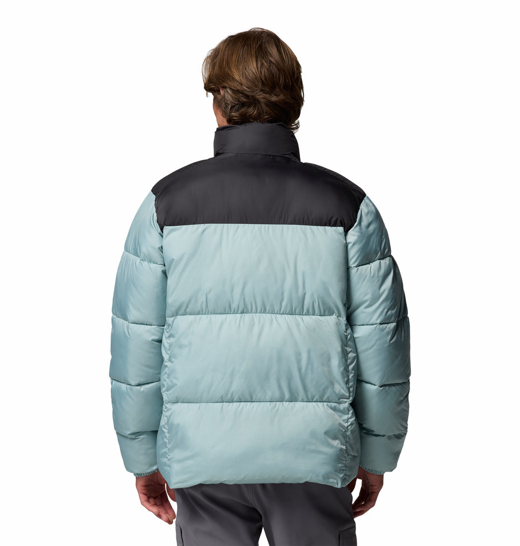 Person wearing a two-tone puffer jacket with a black and light blue design on a white background