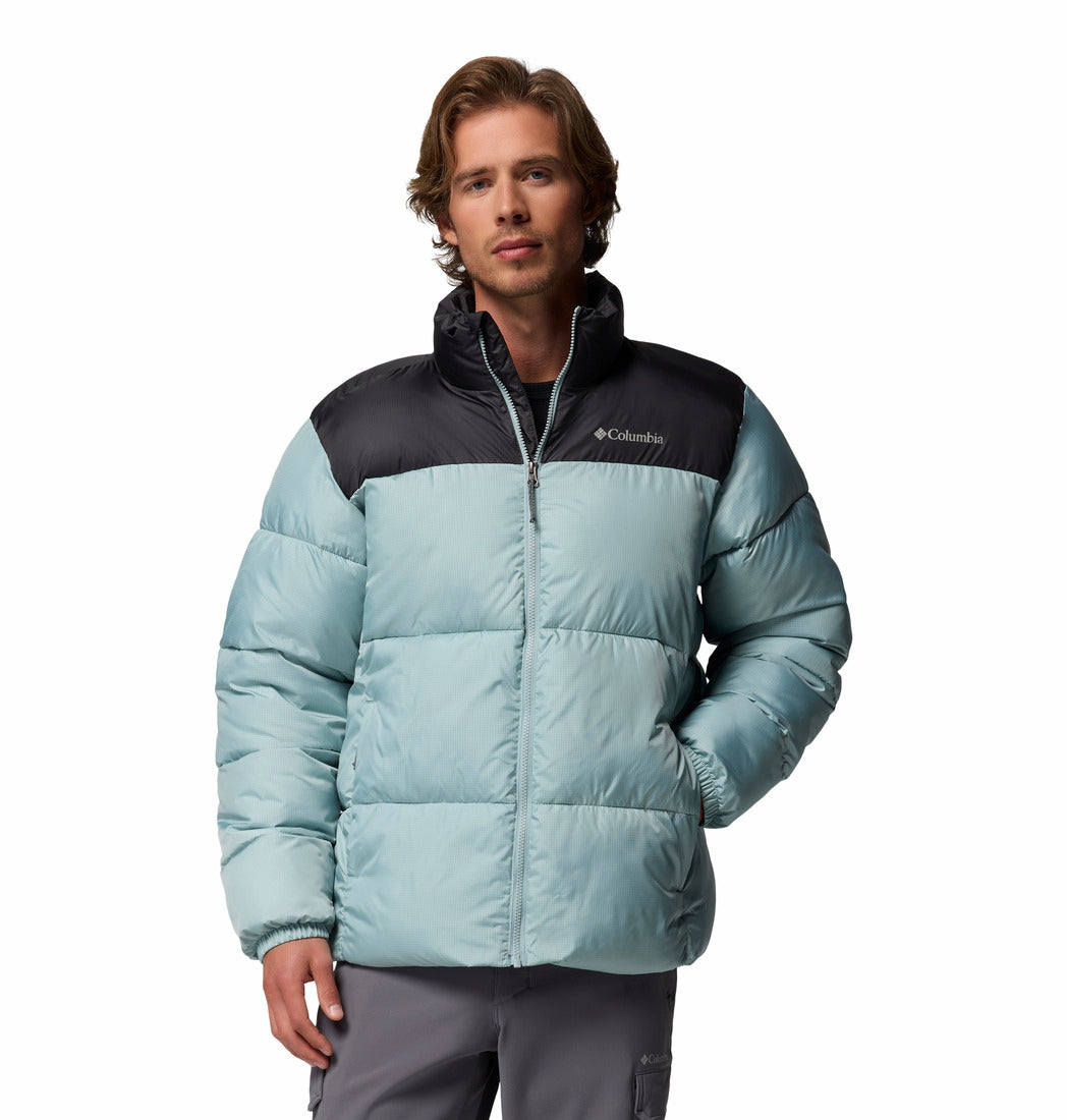 Person wearing a light blue and black puffer jacket with Columbia logo on a white background