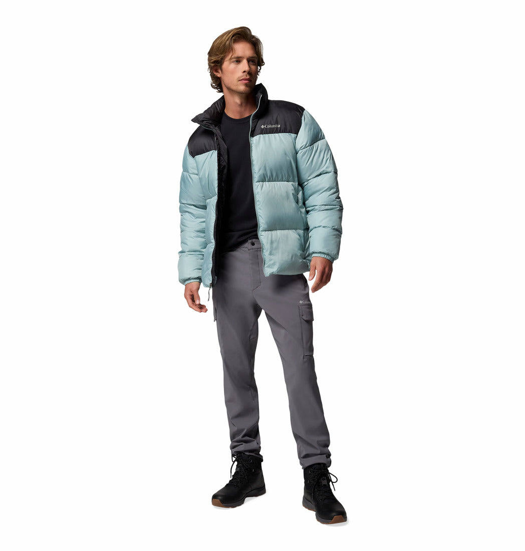 Man wearing a light blue puffer jacket with black accents on a white background