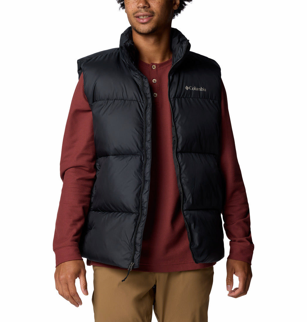 Person wearing a black puffer vest over a red shirt on a white background