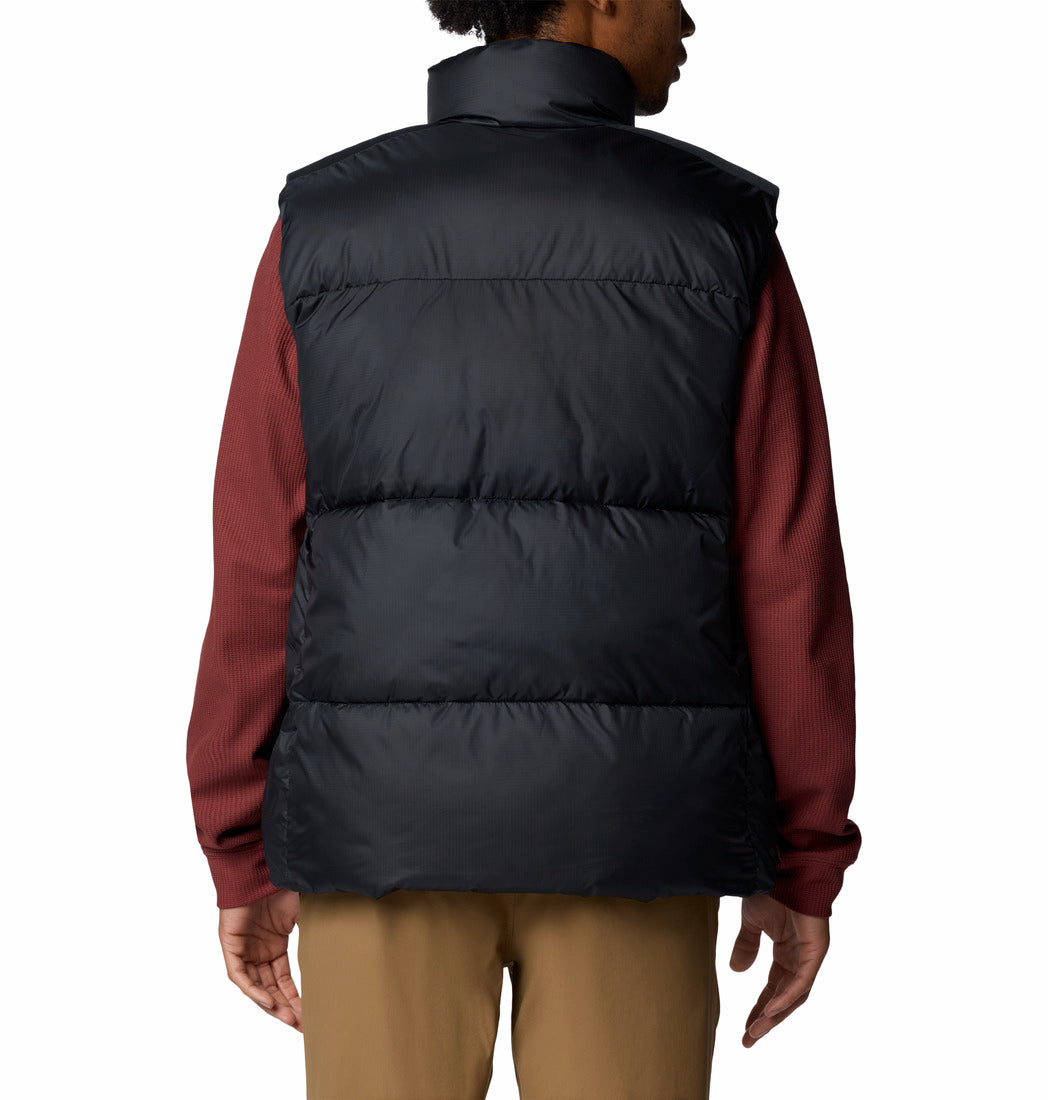Person wearing a black puffer vest over a red shirt on a white background