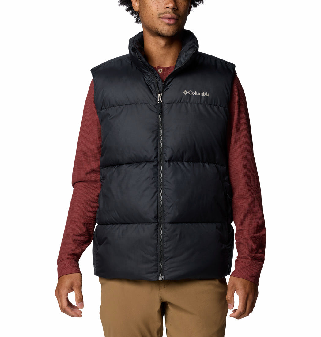 Person wearing a black puffer vest over a red shirt on a white background