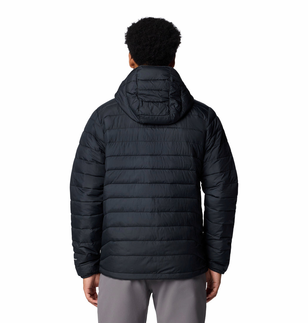 Person wearing a black puffer jacket on a white background