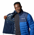 Man wearing a blue Columbia jacket on a white background