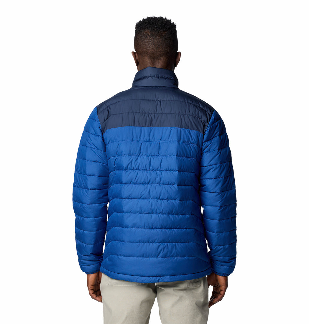 Blue puffer jacket worn by a person on a white background