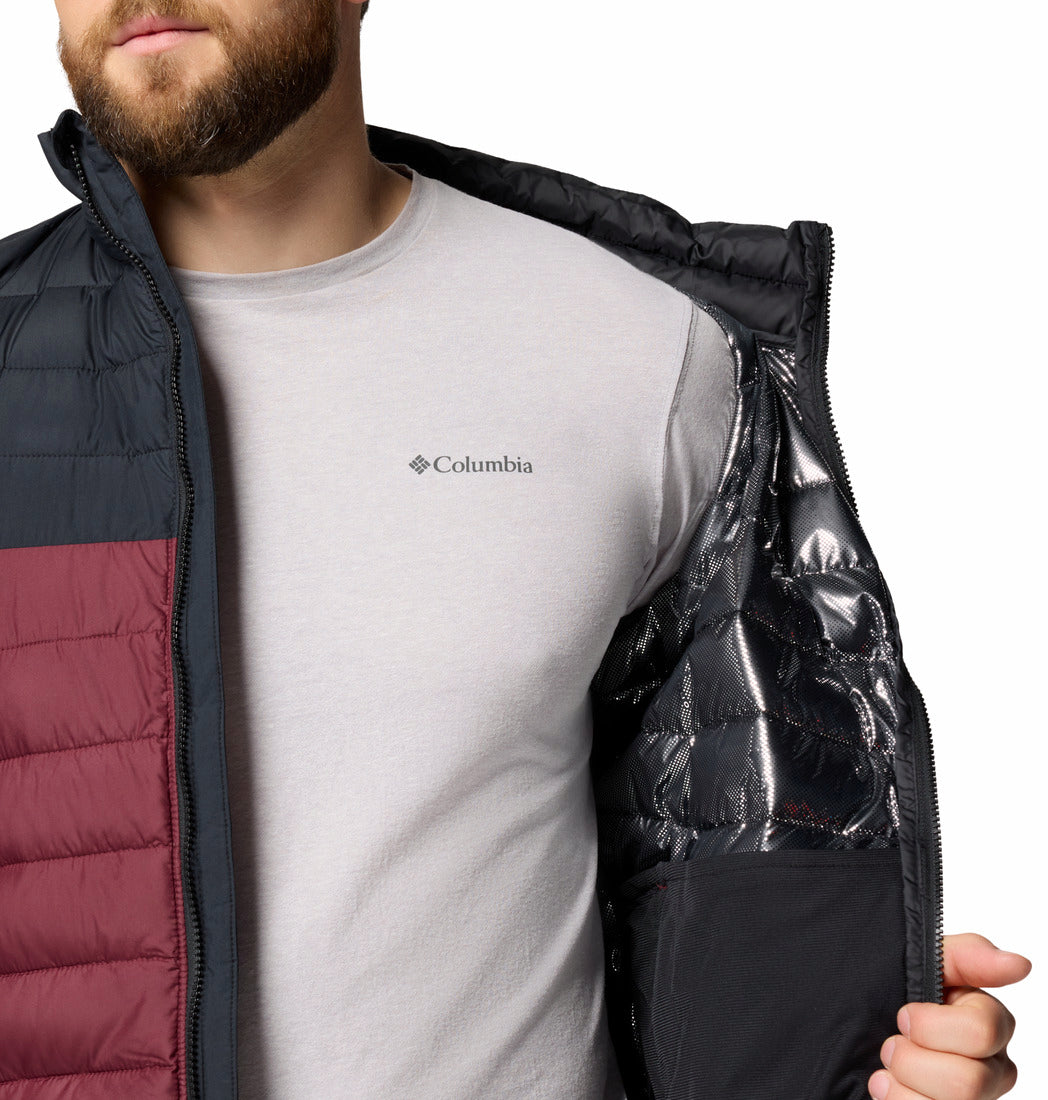 Person wearing a Columbia jacket with a white shirt underneath on a white background