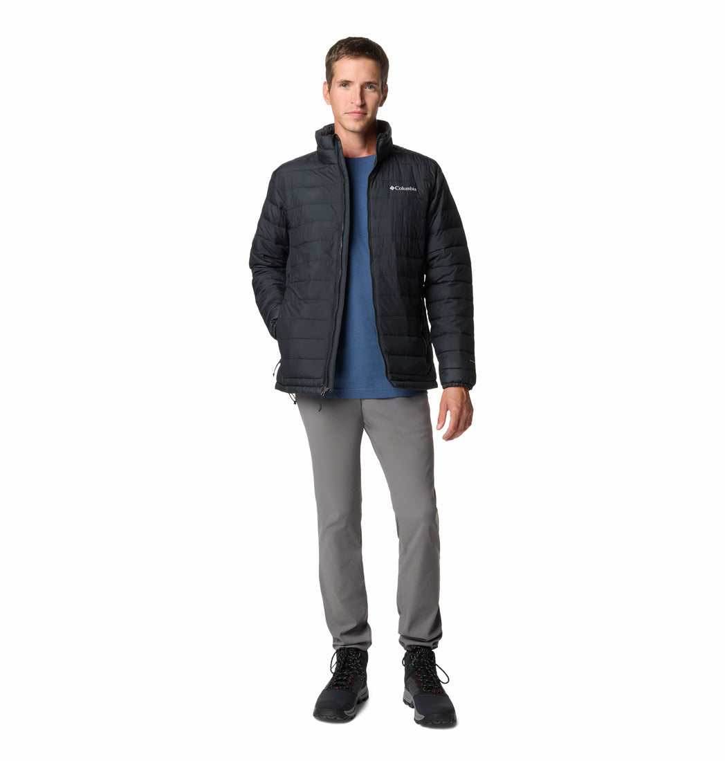 Man wearing a black jacket, blue shirt, gray pants, and black boots on a white background