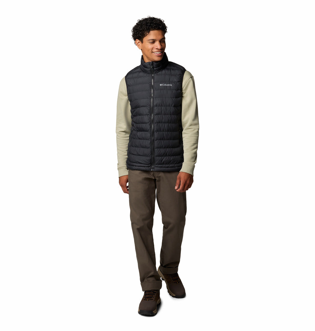 Person wearing a black puffer vest with a visible brand logo on a white background