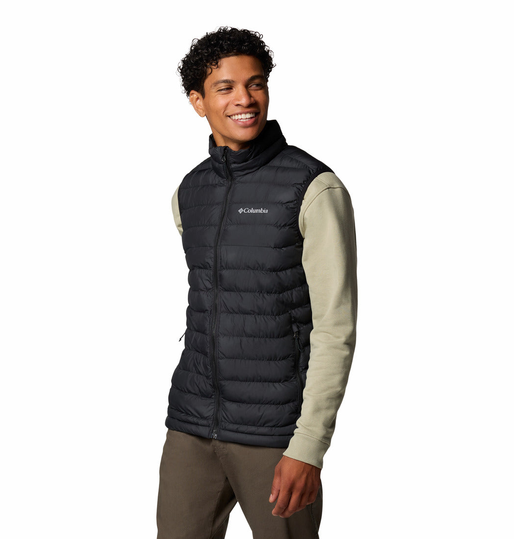 Man wearing a black Columbia puffer vest on a white background