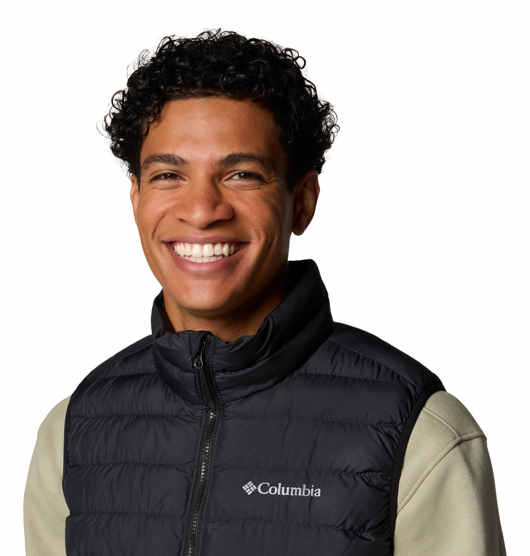 Man wearing a black Columbia vest on a white background