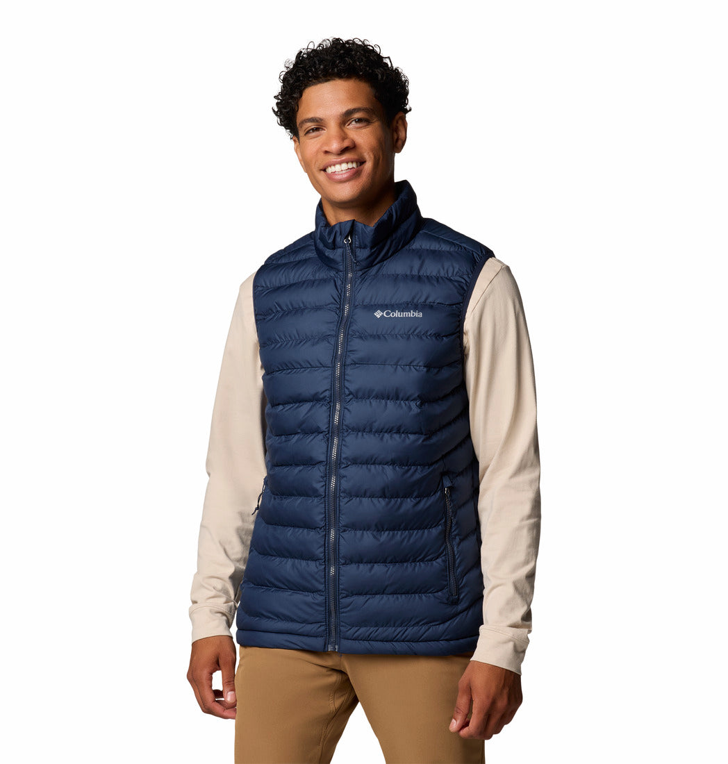 Man wearing a blue Columbia puffer vest on a white background