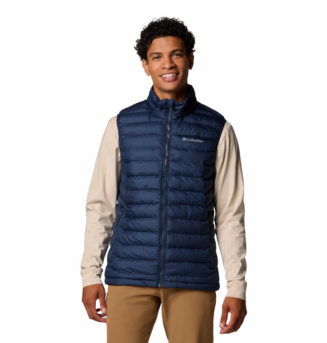 Man wearing a blue puffer vest with Columbia logo on a white background