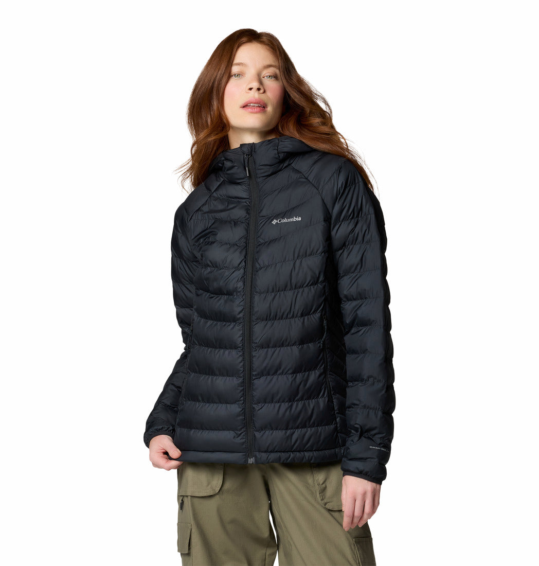 Person wearing a black puffer jacket on a white background