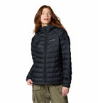 Person wearing a black puffer jacket on a white background