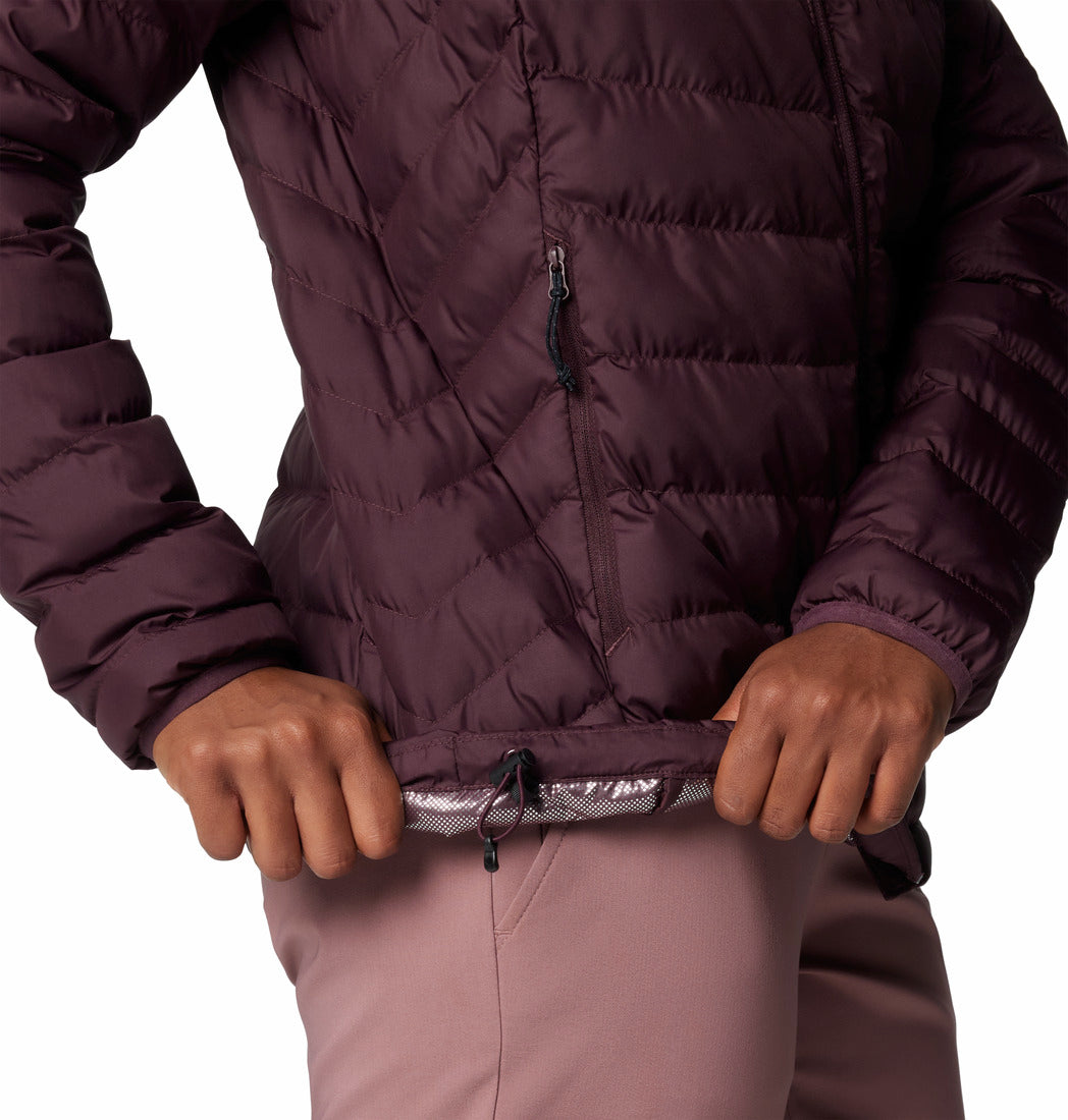 Person wearing a quilted purple jacket with a white background